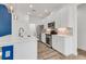 Gourmet kitchen featuring white cabinets, stainless steel appliances, and a quartz countertop island at 484 Landshark Blvd, Daytona Beach, FL 32124