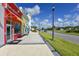 A vibrant street scene captures the essence of a friendly community with colorful storefronts and inviting sidewalks at 484 Landshark Blvd, Daytona Beach, FL 32124