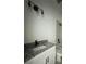 Bright bathroom featuring a granite countertop, white cabinets, and a modern lighting fixture at 516 Model St, Daytona Beach, FL 32114