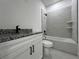 Modern bathroom with granite vanity top, tiled shower and modern fixtures at 516 Model St, Daytona Beach, FL 32114