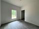 Well-lit bedroom featuring gray flooring and a window offering natural light, perfect for relaxation at 516 Model St, Daytona Beach, FL 32114
