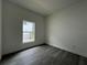 Cozy bedroom with hardwood floors, large windows and neutral paint at 516 Model St, Daytona Beach, FL 32114