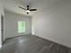 A spacious bedroom features a ceiling fan and modern gray wood-look flooring at 516 Model St, Daytona Beach, FL 32114