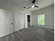 A spacious bedroom features a ceiling fan and modern gray wood-look flooring at 516 Model St, Daytona Beach, FL 32114