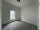 Inviting bedroom with gray floors and a window providing natural light, perfect for a relaxing atmosphere at 516 Model St, Daytona Beach, FL 32114