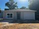 Charming single-story home with a one-car garage and a blue front door at 516 Model St, Daytona Beach, FL 32114