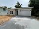 Charming single Gathering home featuring a new driveway and light gray exterior paint at 516 Model St, Daytona Beach, FL 32114