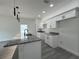 Kitchen features granite countertops, white cabinets and stainless steel appliances at 516 Model St, Daytona Beach, FL 32114