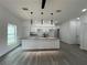 Bright, open-concept kitchen with granite countertops, a kitchen island and stainless steel appliances at 516 Model St, Daytona Beach, FL 32114