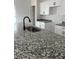 Stylish kitchen featuring granite countertops, stainless steel sink, modern fixtures, and white cabinetry at 516 Model St, Daytona Beach, FL 32114