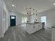Open concept living room and kitchen with modern finishes and stylish light fixtures at 516 Model St, Daytona Beach, FL 32114