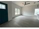 Bright living room with modern ceiling fan, sleek floors, and large windows allowing for plenty of natural light at 516 Model St, Daytona Beach, FL 32114