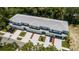 Aerial view showcasing well-maintained townhomes, landscaping, and assigned parking spaces for residents at 561 Coronado Cove Road, New Smyrna Beach, FL 32168