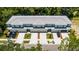 Aerial view of townhomes with private garages, landscaping, and manicured front lawns at 561 Coronado Cove Road, New Smyrna Beach, FL 32168