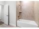 Clean bathroom showcasing a tiled shower with a built-in shower head and a separate tub at 561 Coronado Cove Road, New Smyrna Beach, FL 32168