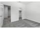 Clean bedroom with gray carpet, neutral walls, and ample closet space, providing a serene and comfortable atmosphere at 561 Coronado Cove Road, New Smyrna Beach, FL 32168