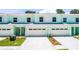 Bright and modern townhomes featuring individual driveways and attached garages at 561 Coronado Cove Road, New Smyrna Beach, FL 32168