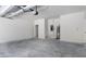 Spacious garage with overhead lighting and room for storage at 561 Coronado Cove Road, New Smyrna Beach, FL 32168