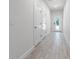 Well-lit hallway featuring wood-look tile flooring and access to other rooms at 561 Coronado Cove Road, New Smyrna Beach, FL 32168