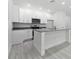 Kitchen with island, granite countertops, and stainless steel appliances at 561 Coronado Cove Road, New Smyrna Beach, FL 32168