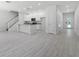 Bright, open-concept kitchen featuring white cabinetry, gray counters, and modern stainless steel appliances at 561 Coronado Cove Road, New Smyrna Beach, FL 32168