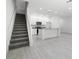 Open-concept living space with stairs and a modern kitchen at 561 Coronado Cove Road, New Smyrna Beach, FL 32168