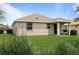 A well maintained backyard with a covered porch and manicured lawn at 5610 Nw 37Th Lane Rd, Ocala, FL 34482