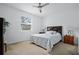 Comfortable bedroom features neutral carpet, ceiling fan, and large window at 5610 Nw 37Th Lane Rd, Ocala, FL 34482