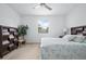 Comfortable bedroom features neutral carpet, ceiling fan, and large window at 5610 Nw 37Th Lane Rd, Ocala, FL 34482