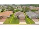 Aerial view of well-maintained home featuring a two-car garage and nicely landscaped front yard at 5610 Nw 37Th Lane Rd, Ocala, FL 34482