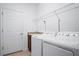 Functional laundry room with washer, dryer, and sink with tiled floors at 5610 Nw 37Th Lane Rd, Ocala, FL 34482