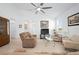 Bright living room with tile flooring, a ceiling fan, and ample natural light at 5610 Nw 37Th Lane Rd, Ocala, FL 34482