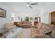 Spacious living room offering an open floorplan with a ceiling fan and large windows at 5610 Nw 37Th Lane Rd, Ocala, FL 34482