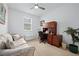 Bright home office featuring a large desk and comfortable seating with a ceiling fan at 5610 Nw 37Th Lane Rd, Ocala, FL 34482