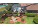Aerial view of home highlighting the backyard screened-in pool with outdoor seating and patio area amidst landscaped gardens at 585 Summerhaven Dr, Debary, FL 32713