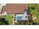 Aerial view of home, highlighting the screened in pool, patio area, manicured garden, and lush landscaping at 585 Summerhaven Dr, Debary, FL 32713