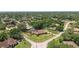 A high angle aerial shot of a home in a suburban neighborhood with mature trees and landscaping at 585 Summerhaven Dr, Debary, FL 32713