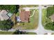Aerial view of a home with a landscaped yard, pool, screened patio, and mature trees, capturing a neighborhood setting at 585 Summerhaven Dr, Debary, FL 32713