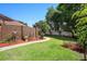 Landscaped backyard with a winding walkway, decorative brick wall, and lush greenery at 585 Summerhaven Dr, Debary, FL 32713