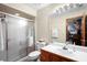 Clean bathroom with a glass-enclosed shower, vanity, and neutral tile; practical and well-maintained space at 585 Summerhaven Dr, Debary, FL 32713