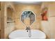 Upscale bathroom with a soaking tub, custom tiled walls, and an octagon window feature at 585 Summerhaven Dr, Debary, FL 32713