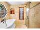 Stylish bathroom with a soaking tub, glass shower, and tiled walls at 585 Summerhaven Dr, Debary, FL 32713