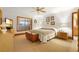Cozy bedroom with natural light, wooden accents, and warm-toned carpet at 585 Summerhaven Dr, Debary, FL 32713