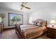 Comfortable bedroom with carpet flooring, large window, and traditional furnishings at 585 Summerhaven Dr, Debary, FL 32713