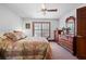 Bedroom with floral bedspread, wood furniture, window and ceiling fan at 585 Summerhaven Dr, Debary, FL 32713