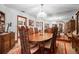 Elegant dining room with wood table, ornate chairs, mirrored wall, and vintage chandelier at 585 Summerhaven Dr, Debary, FL 32713