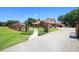 Gated brick home with a manicured lawn and a long, private driveway at 585 Summerhaven Dr, Debary, FL 32713