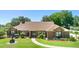 Charming brick home featuring a well-manicured front lawn and classic architectural details at 585 Summerhaven Dr, Debary, FL 32713