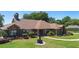 Lovely brick home with well-kept lawn, mature trees, and a walkway to the bright front door and chimney at 585 Summerhaven Dr, Debary, FL 32713