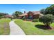 Brick home with manicured landscaping, lush lawn and inviting walkway at 585 Summerhaven Dr, Debary, FL 32713